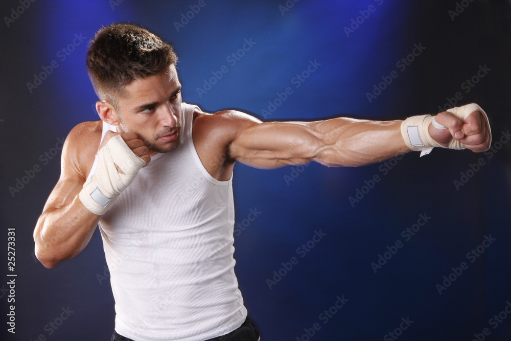 Toned boxer working with hand wraps Toned boxer working with hand wraps