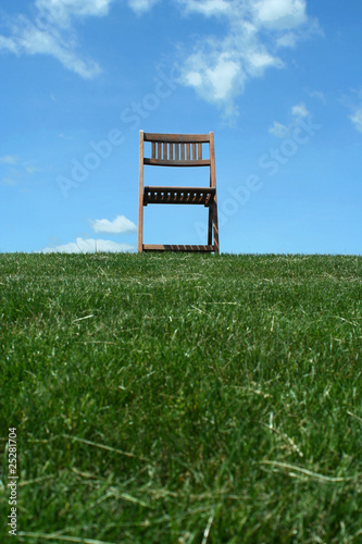 Wooden chair on a hilltop photo