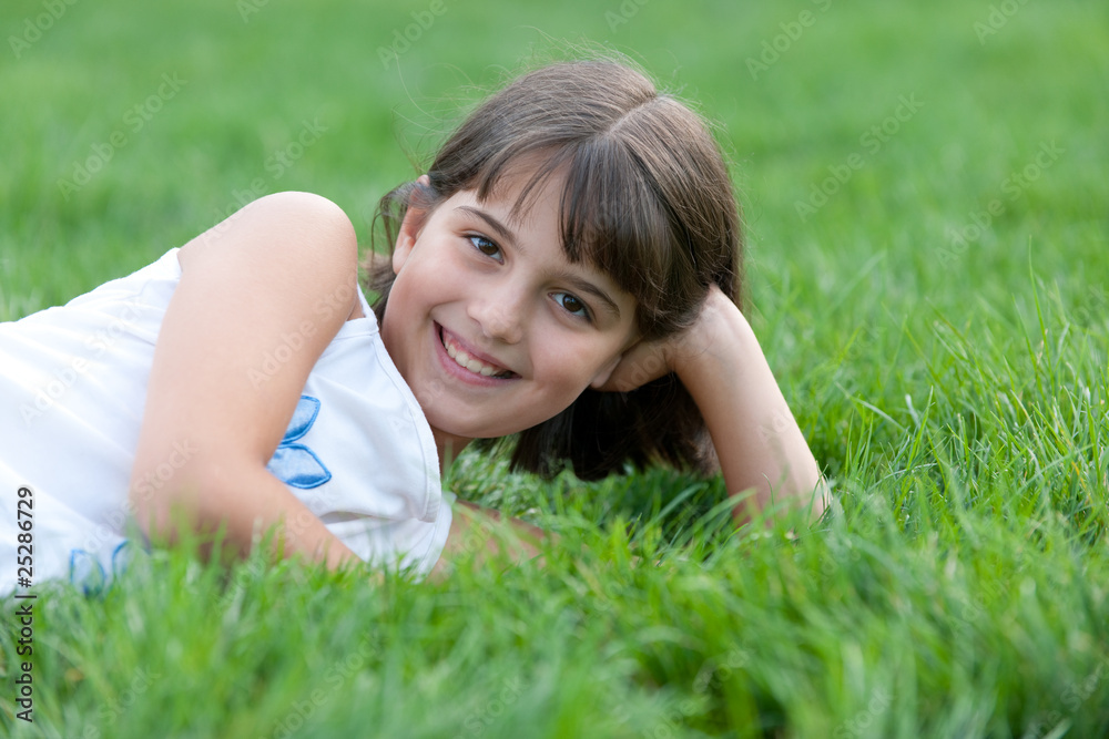 Closeup portrait of a pretty girl lying in the summer park Closeup portrait of a pretty girl lying in the summer park