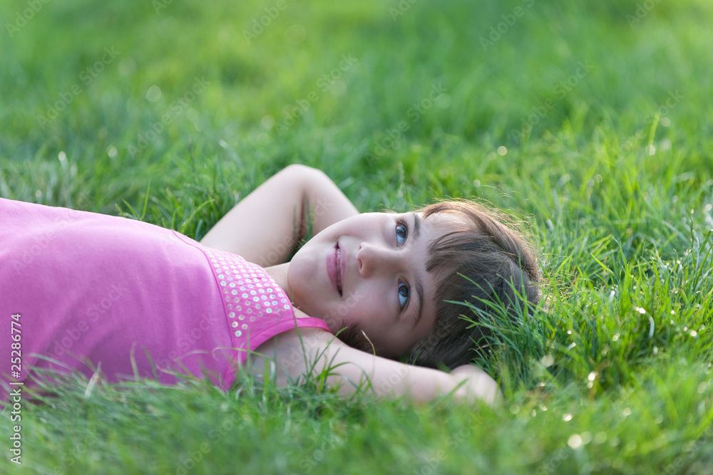 Closeup portrait of a dreaming girl lying in the summer park Closeup portrait of a dreaming girl lying in the summer park