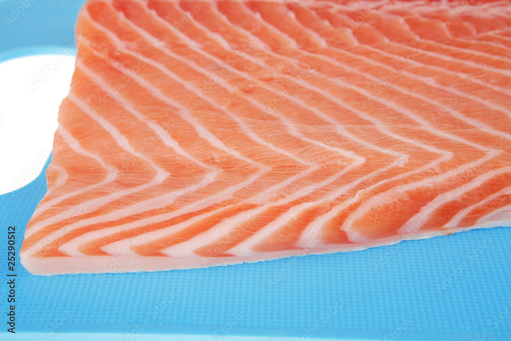 raw salmon fillet on blue plate