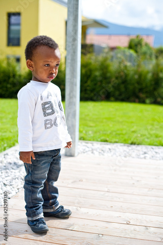 Young baby boy in the garden
