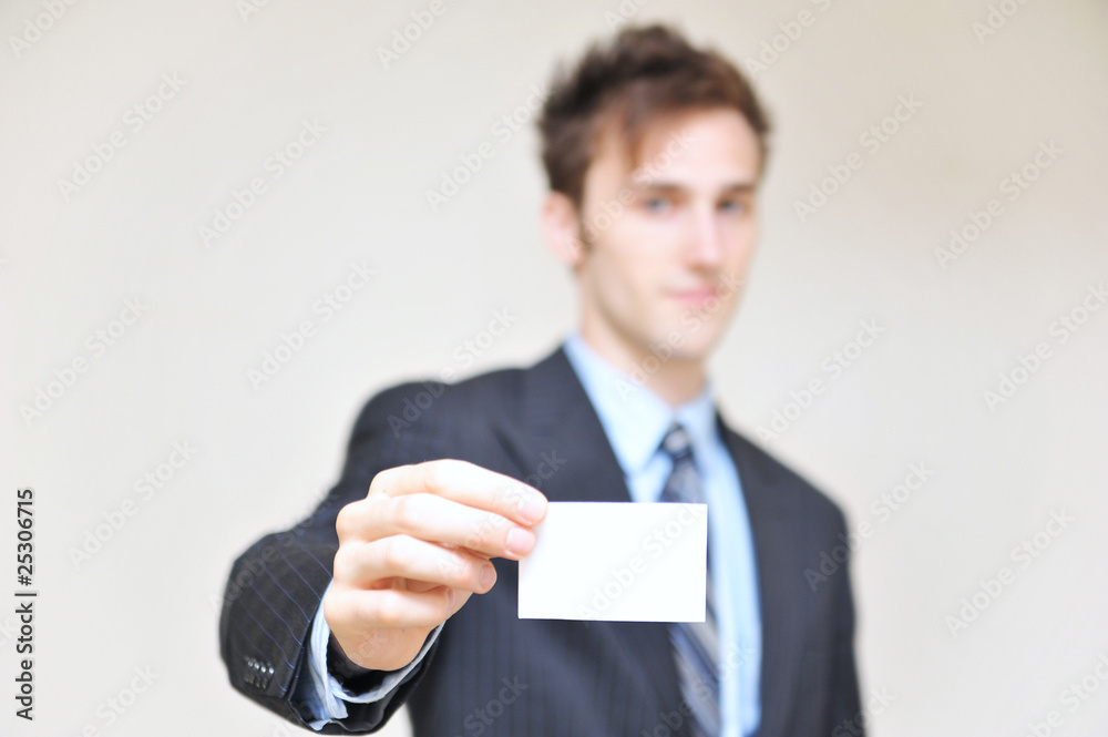 portrait of a young businessman holding blank card portrait of a young businessman holding blank card