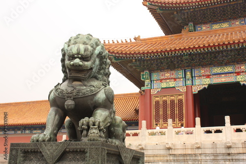 Bronze lion is guarding Forbidden City in Beijing, China