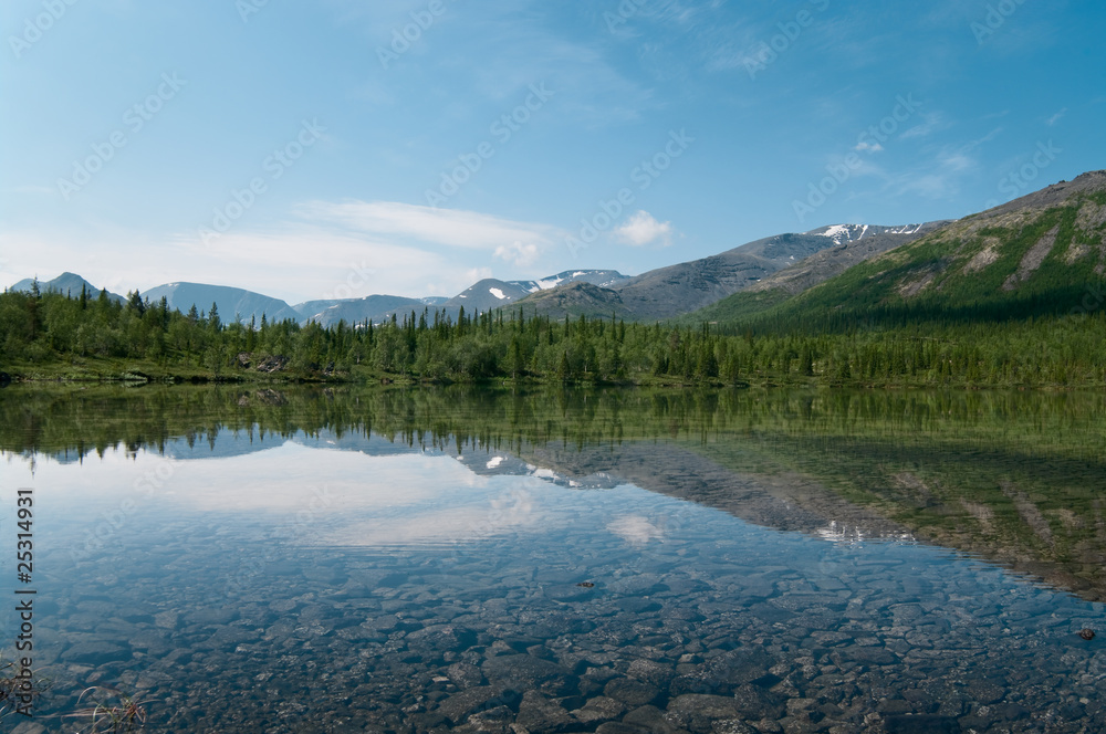 Lake in mountains and forest around it. Khibins massive, Russia