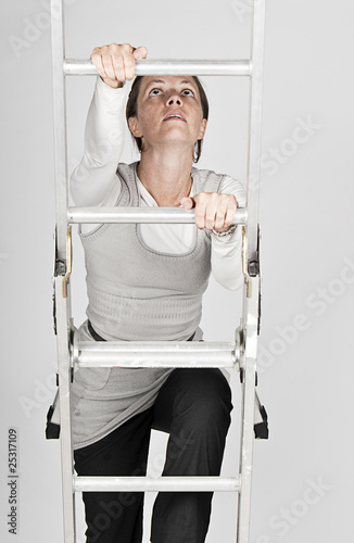 Woman Climbing a Ladder