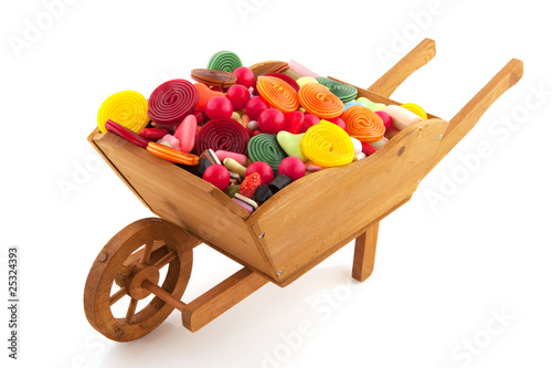 Canvas Print Wheel barrow with lots of candy