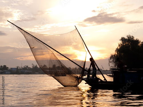 Fishing boat with net silhouette in Can Tho, Mekong delta, Vietnam photo