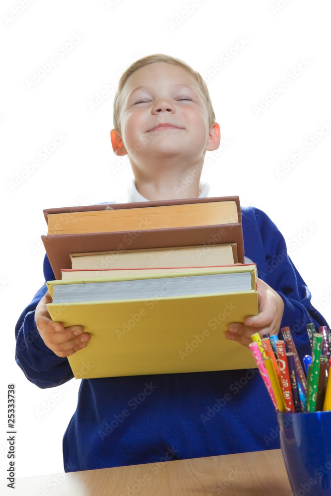 smiling boy holding a heap of books, isolated smiling boy holding a heap of books, isolated