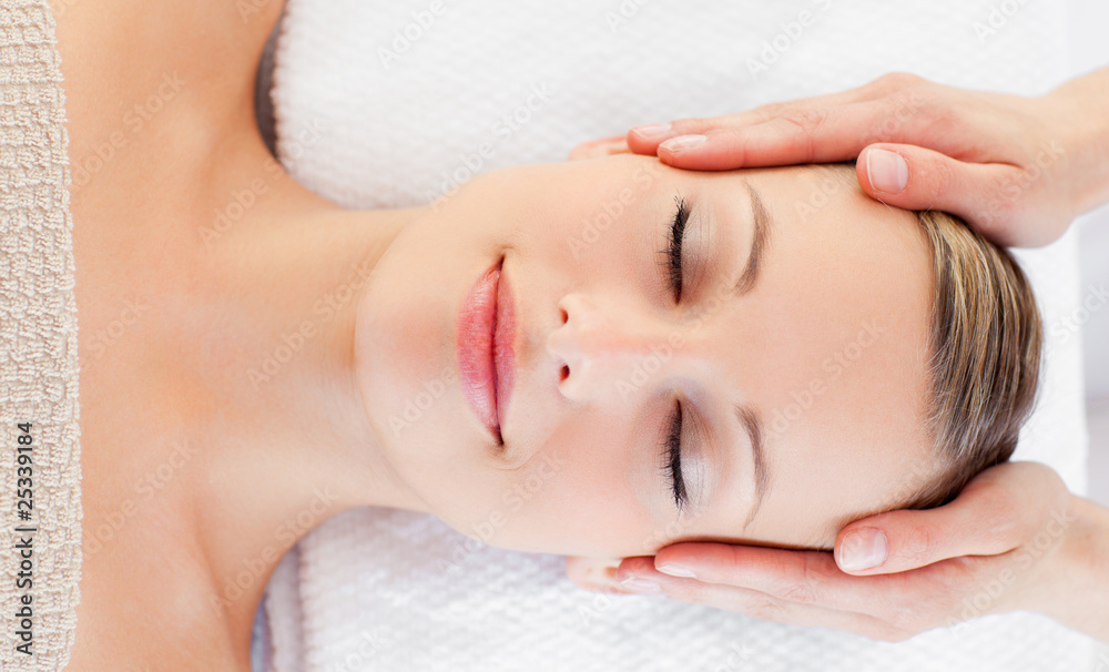 Young relaxed woman receiving a head massage Young relaxed woman receiving a head massage