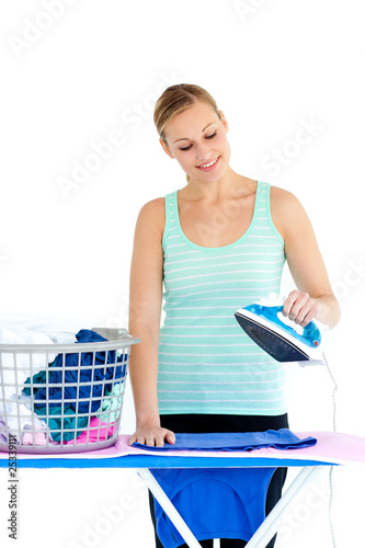 Bright woman ironing her clothes photo