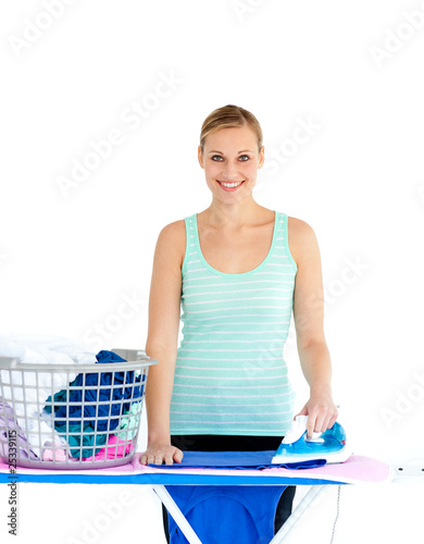 Joyful woman ironing her clothes photo