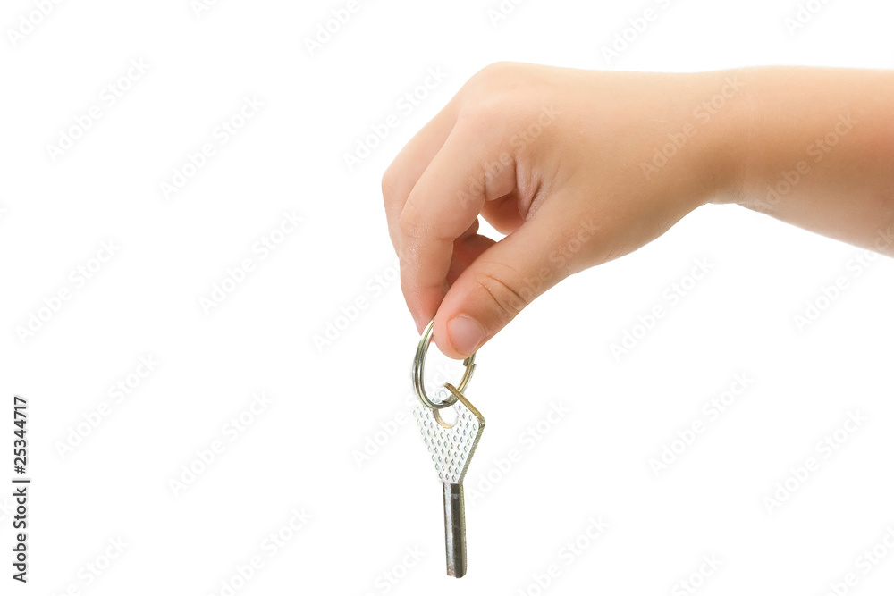 The children's hand holds the key from the lock The children's hand holds the key from the lock
