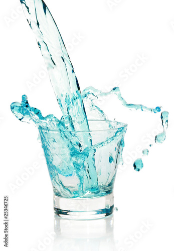 Glass with splashing blue drink © jagodka