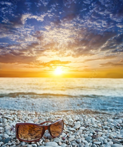 sunglasses  on a sea coast at the evening