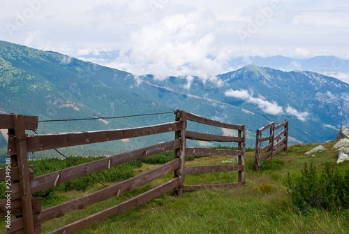 wooden fence in a mountain meadow