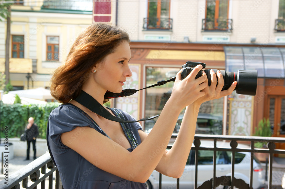 Woman photographer on city street Woman photographer on city street