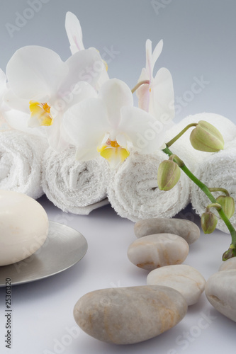 White rolled towels with orchid and soap