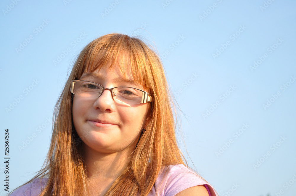 Beautiful, red-haired, young girl happy, blue sky background Beautiful, red-haired, young girl happy, blue sky background