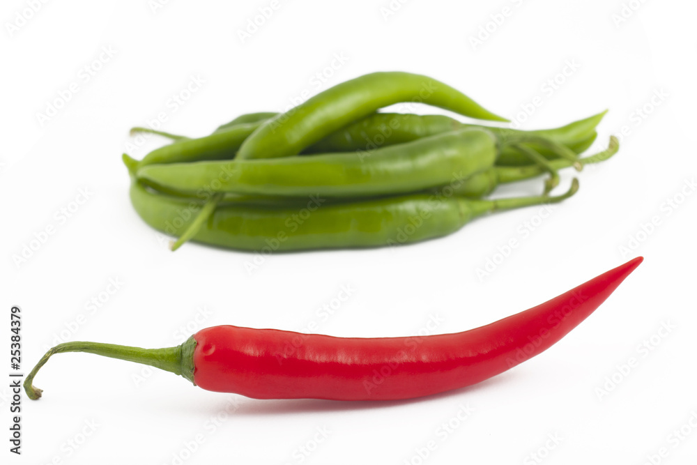 Red chili peppers on green chili peppers background