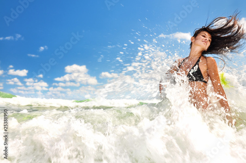 Beautiful girl splashing in the ocean