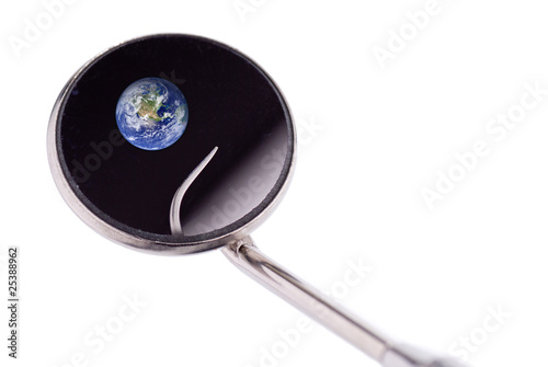 Dentist mirror and hook showing earth from space