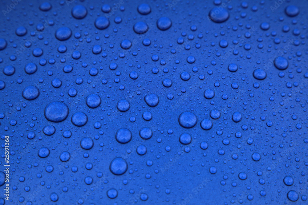 rain drops on a blue car body, shallow focus