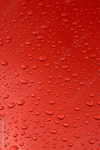 rain drops on orange car body, shallow focus