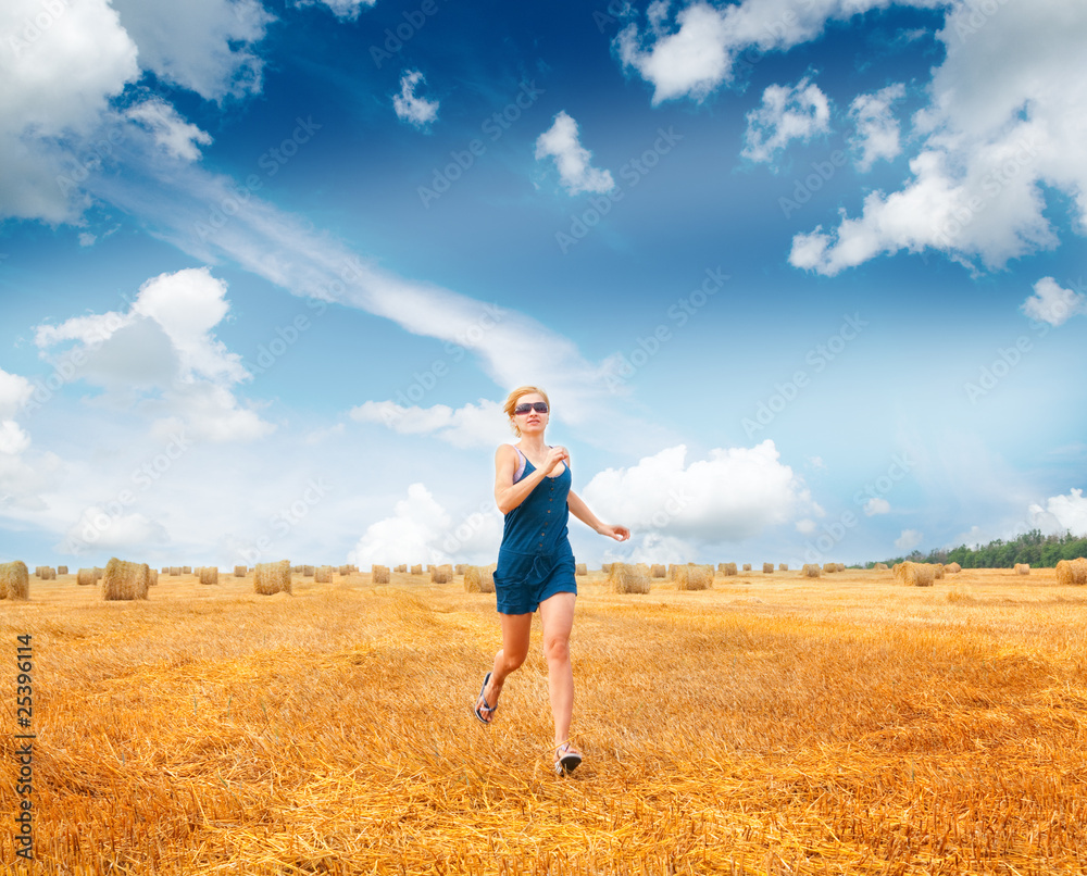 Woman Running Through Summer Harvested Field Woman Running Through Summer Harvested Field