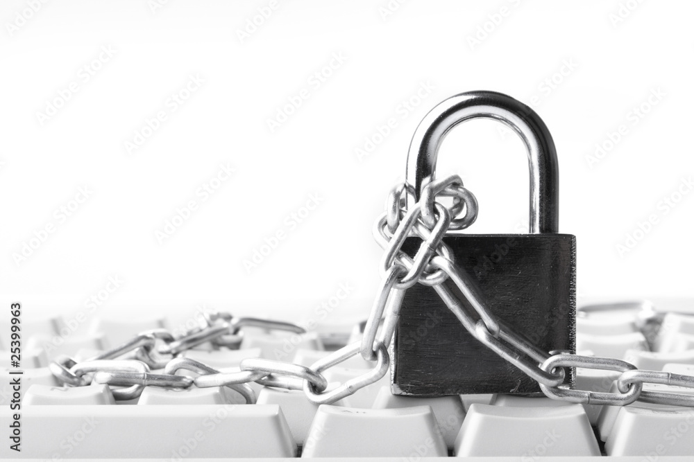 Computer keyboard secured with chain and padlock.. Computer keyboard secured with chain and padlock..