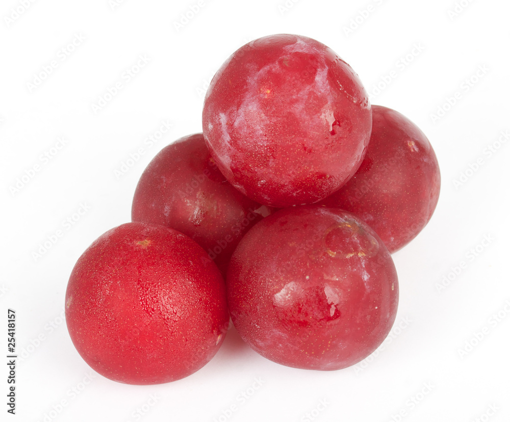 Shiny purple plum isolated against white background Shiny purple plum isolated against white background