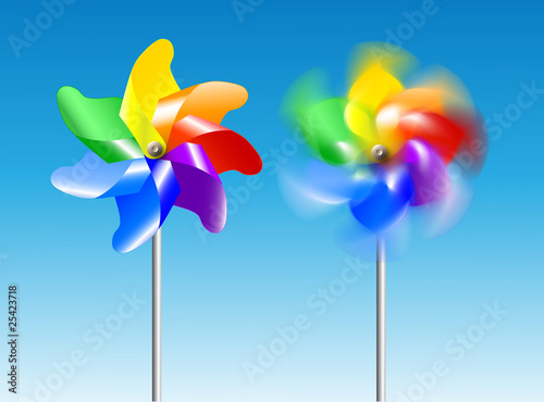 set of two pinwheel toys- one still and second is rotating on the blue sky background.
