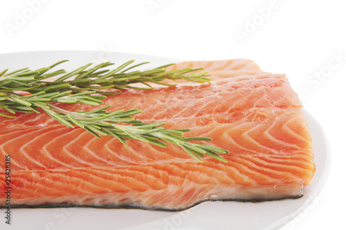 salmon fillet on white plate and rosemary
