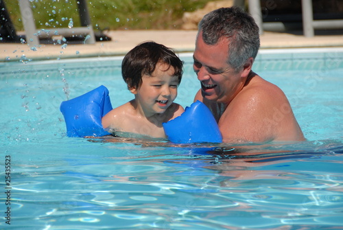 Father and Son Playing in Swimming Pool
