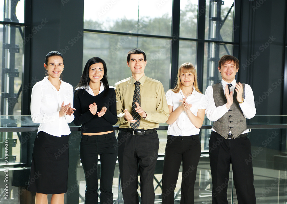 Obraz premium Five young business persons in a modern office