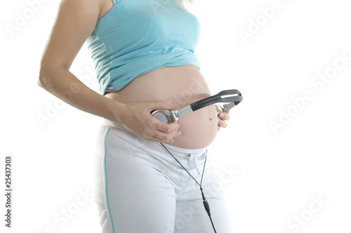 Pregnent woman with the headphones photo