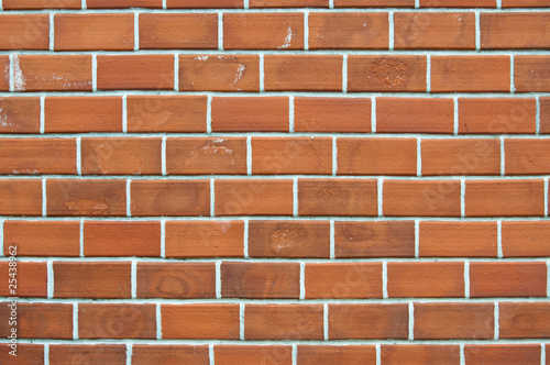 Old red brick wall background with uneven structure