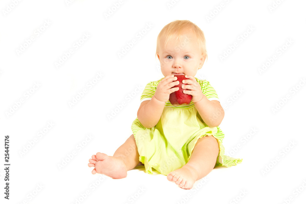Young little baby eat red apple on white Young little baby eat red apple on white