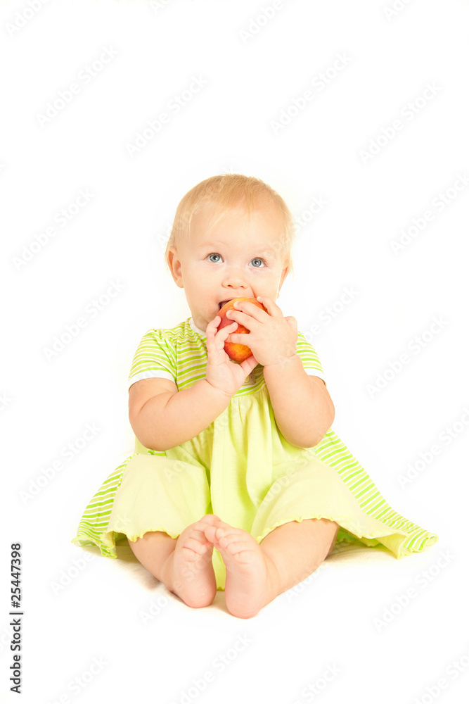 Young little baby eat red peach on white Young little baby eat red peach on white
