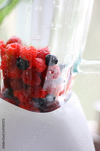 Fresh berry mix in blender photo