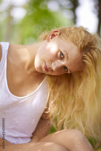 Blond girl in summer park