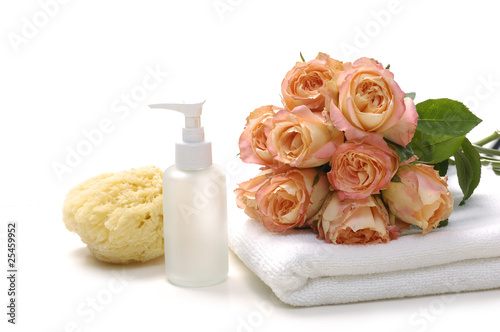 spa accessory with pink rose on towel
