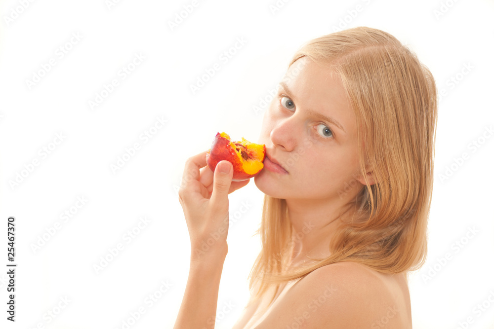 Beautiful young girl eating a peach on white Beautiful young girl eating a peach on white