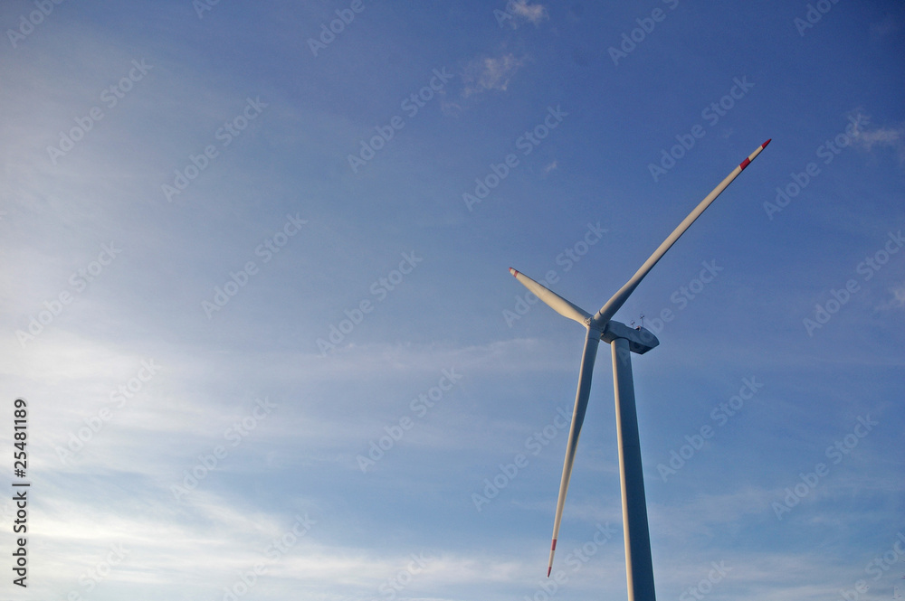 Wind turbine under blue sky