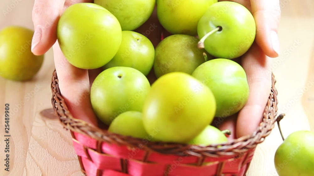 Woman is throwing fruits into basket. Woman is throwing fruits into basket.