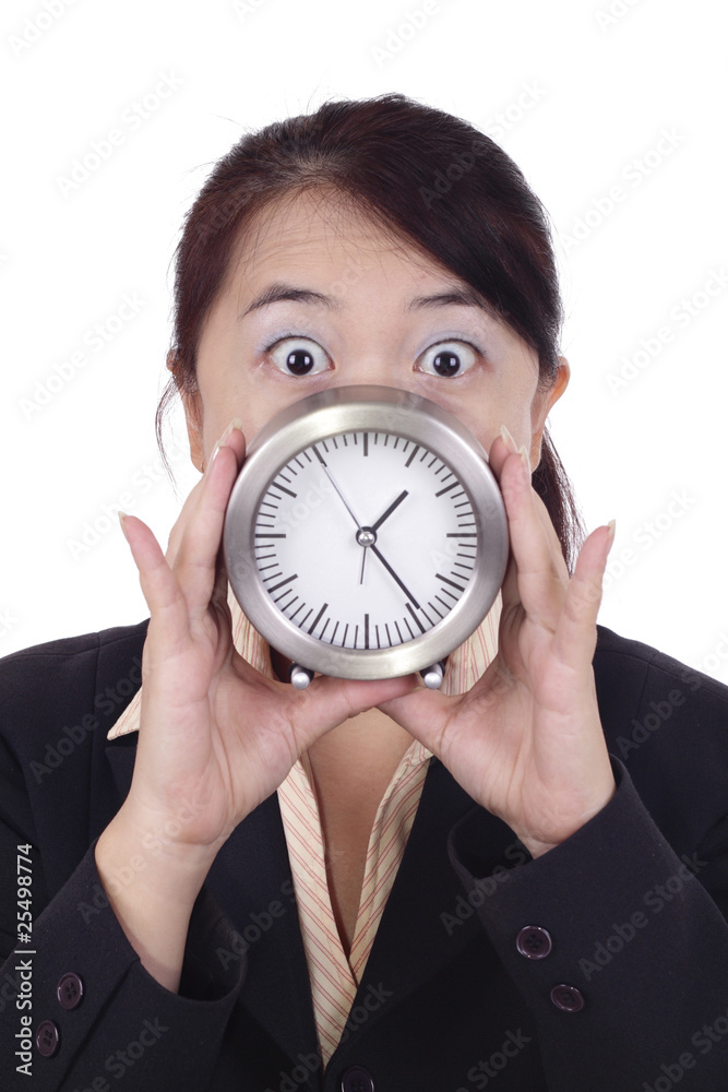 Asian businesswoman shocked holding a table clock Asian businesswoman shocked holding a table clock