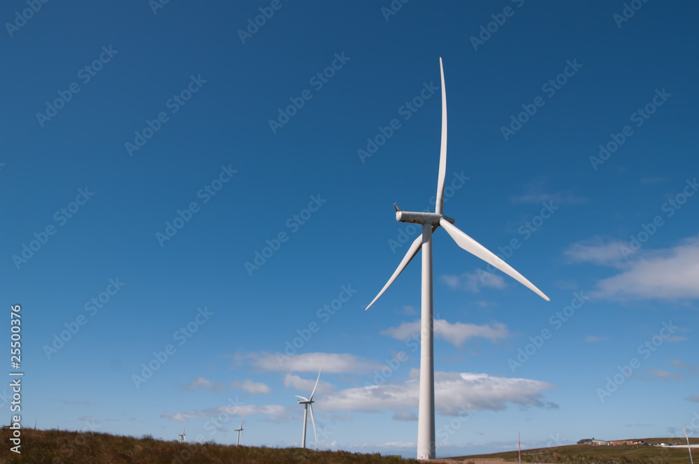 Four wind turbines in blue summer sky Four wind turbines in blue summer sky