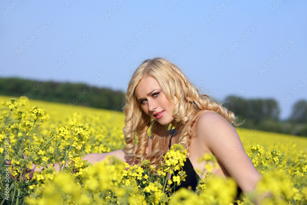 Beautiful young blonde woman in a field of wildflowers. Beautiful young blonde woman in a field of wildflowers.