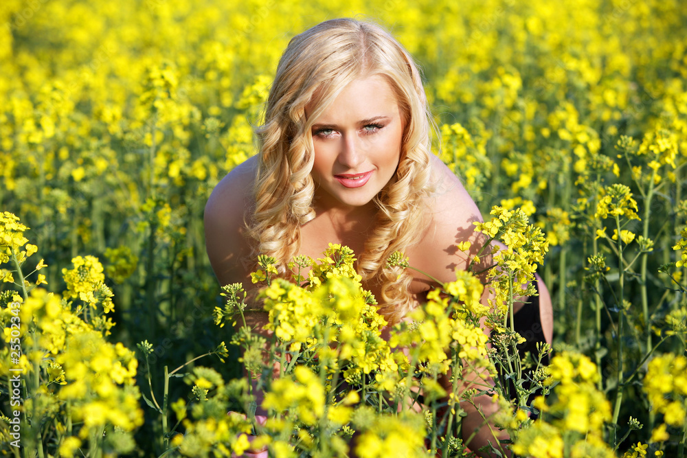 Beautiful young blonde woman in a field of wildflowers. Beautiful young blonde woman in a field of wildflowers.