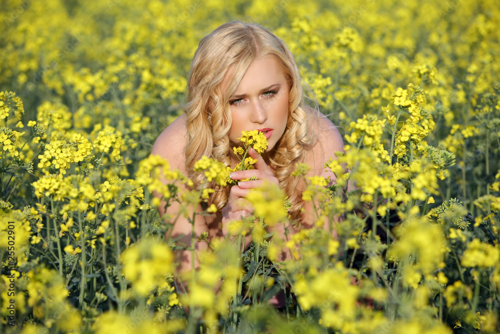 Beautiful young blonde woman in a field of wildflowers. Beautiful young blonde woman in a field of wildflowers.